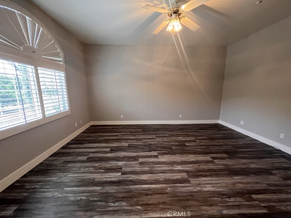 8715 Dufferin Avenue Riverside, CA 92504 - Photo 14 of 27 a view of an empty room with wooden floor and a window