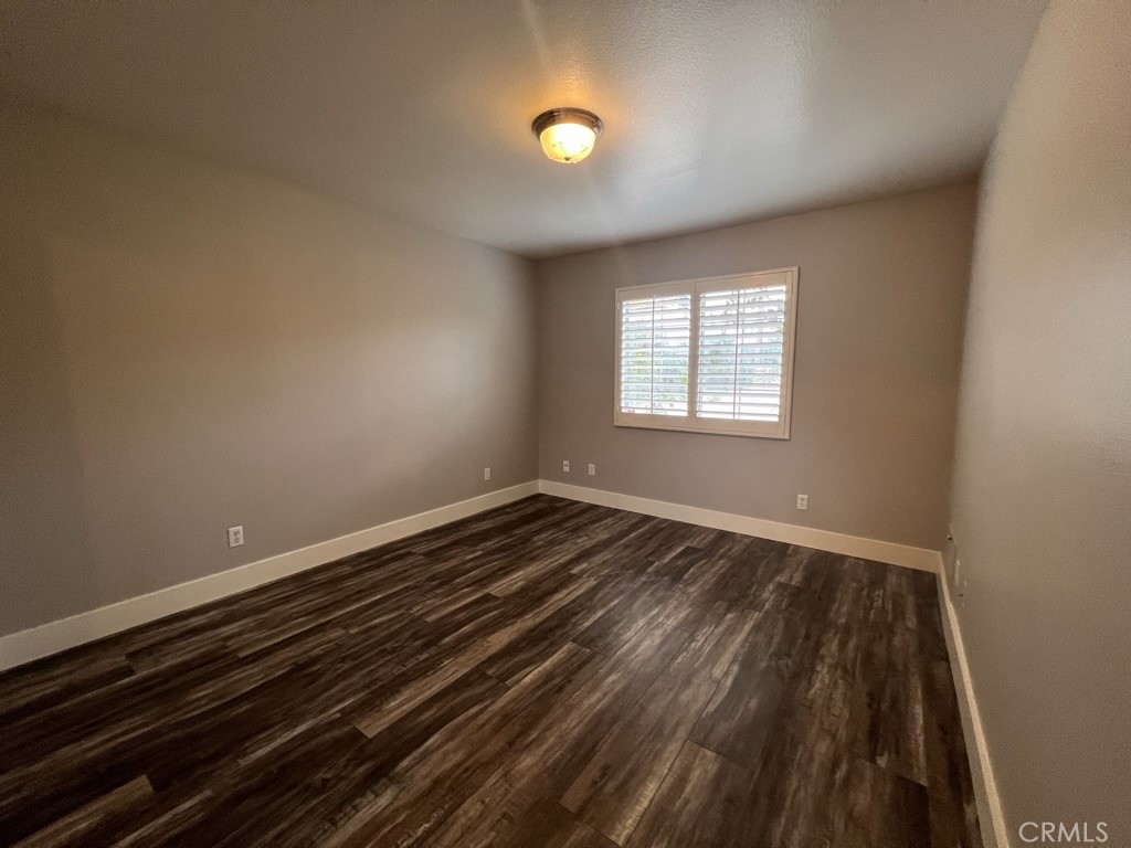 8715 Dufferin Avenue Riverside, CA 92504 - Photo 16 of 27 an empty room with wooden floor and windows