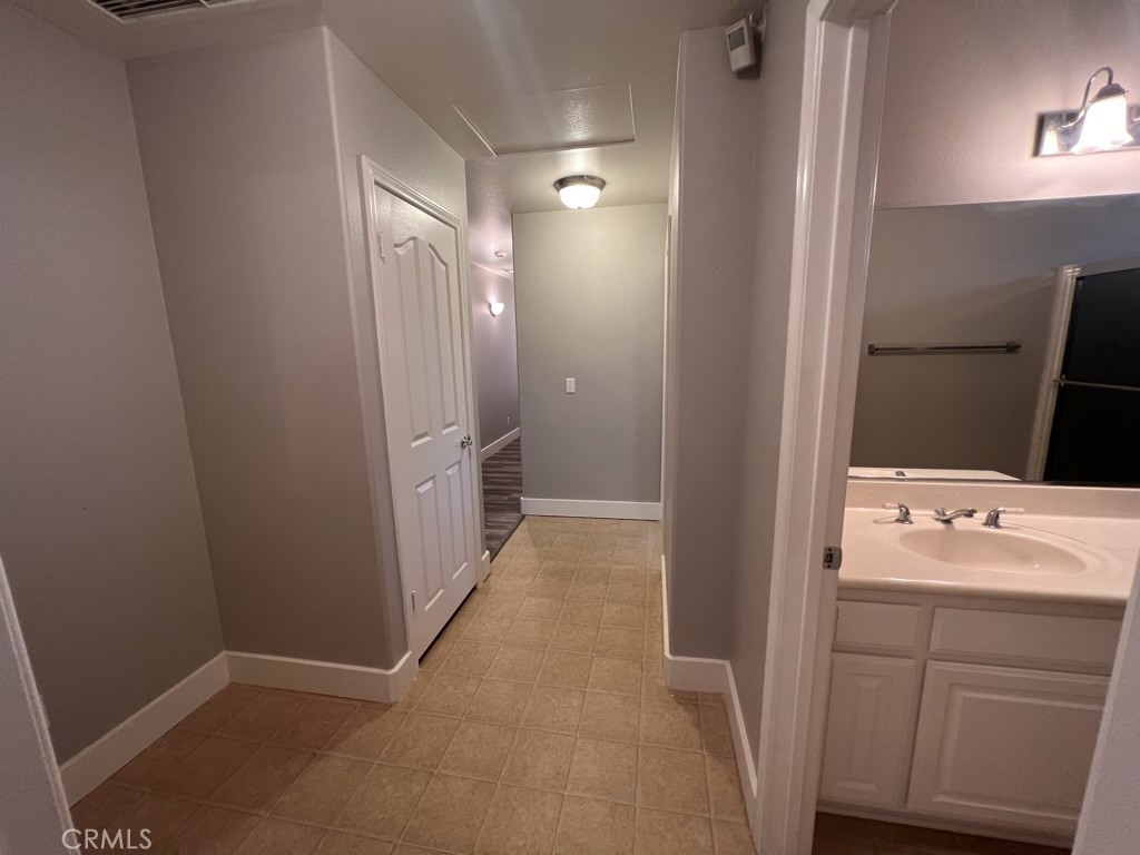 8715 Dufferin Avenue Riverside, CA 92504 - Photo 19 of 27 a bathroom with a double vanity sink and mirror