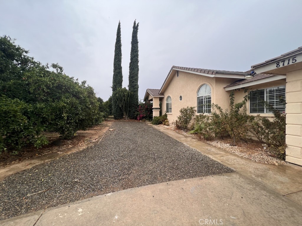 8715 Dufferin Avenue Riverside, CA 92504 - Photo 22 of 27 a view of a house with a yard and potted plants