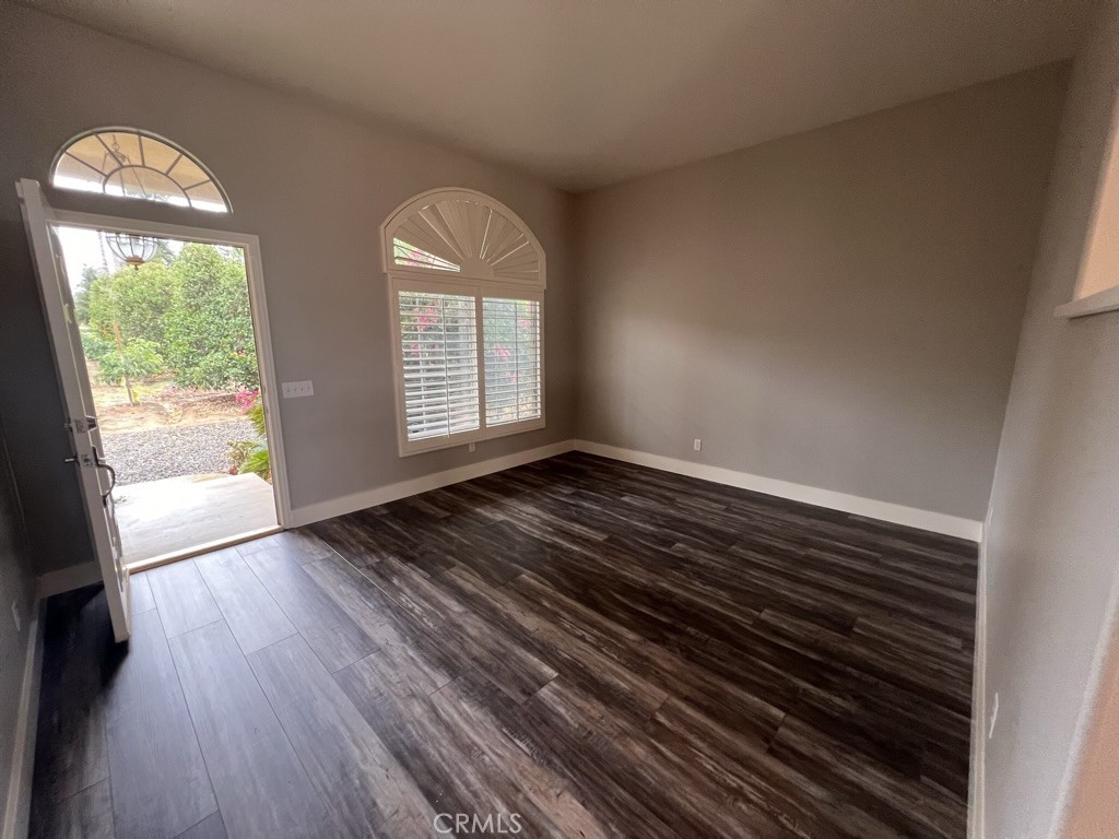8715 Dufferin Avenue Riverside, CA 92504 - Photo 3 of 27 a view of empty room with wooden floor and fan