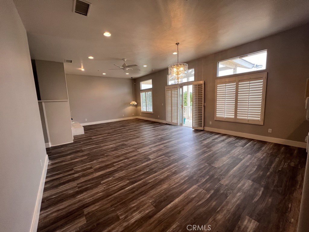 8715 Dufferin Avenue Riverside, CA 92504 - Photo 4 of 27 an empty room with wooden floor and windows