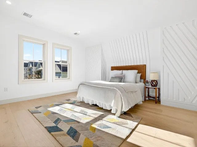 a bedroom with double bed and a window