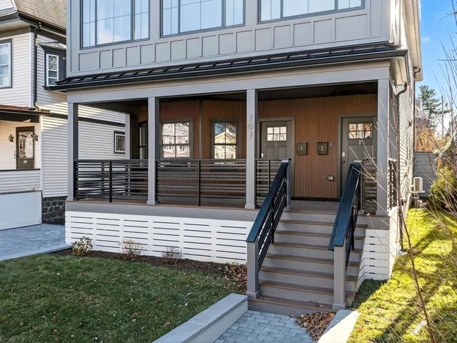 a view of a house with wooden fence and a stairs