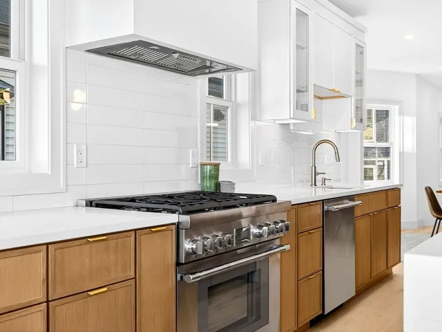 a kitchen with stainless steel appliances granite countertop a stove and a sink