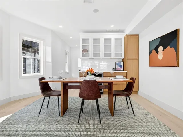 a view of a dining room with furniture and window