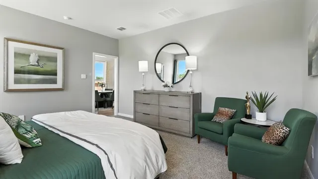 a bedroom with a bed and a dresser