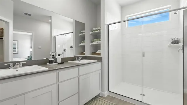 a bathroom with a granite countertop sink a mirror and a shower