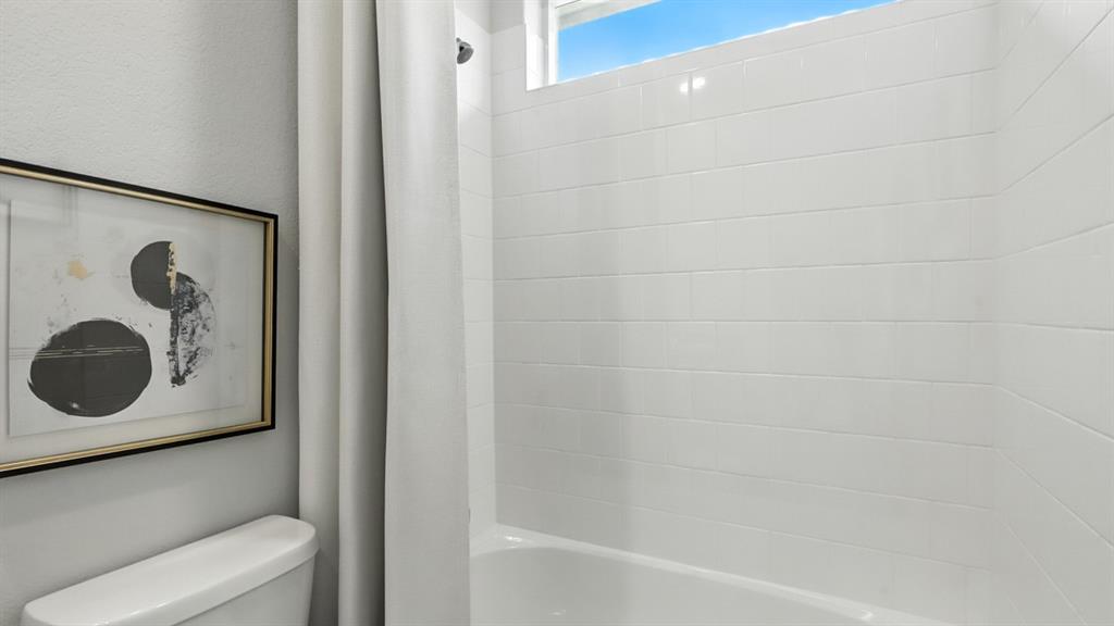 313 Potato Street Keene, TX 76059 - Photo 26 of 40 a bathroom with a bathtub and a shower