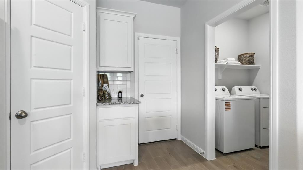 313 Potato Street Keene, TX 76059 - Photo 6 of 40 a room with a washer and dryer