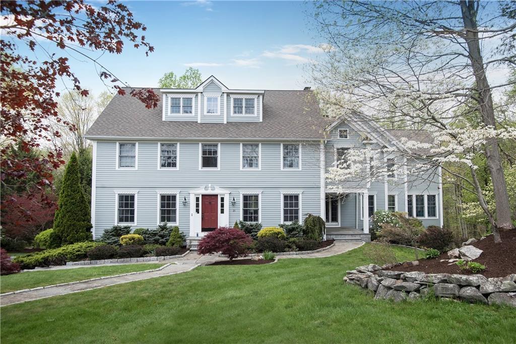21 Pilgrim Hill Road Ridgefield, CT 06877 - Photo 1 of 1 a front view of a house with a garden
