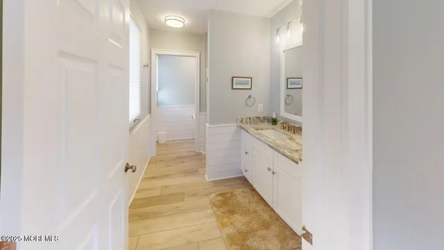a bathroom with a granite countertop sink a toilet and shower