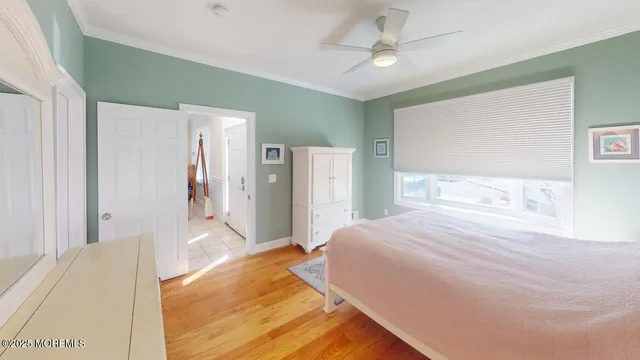 a spacious bedroom with a bed and a chandelier
