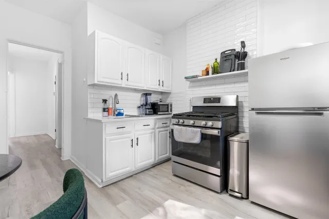 a kitchen with cabinets and appliances
