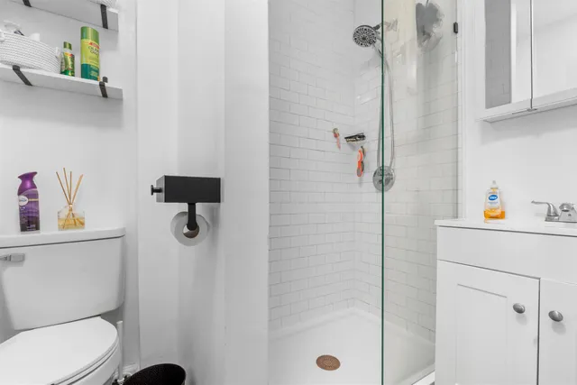 a white toilet sitting next to a bathroom sink
