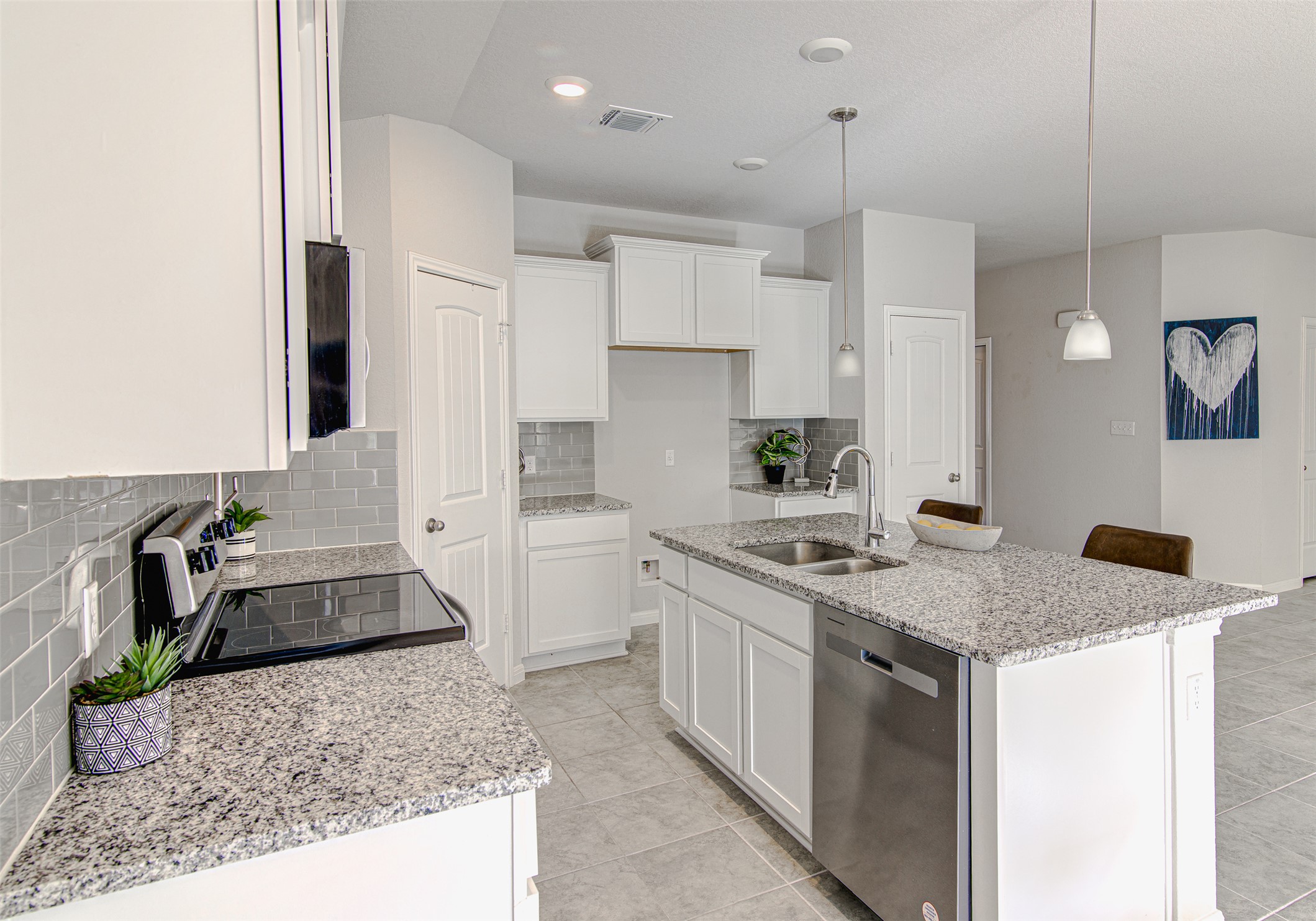 316 Pepper Mill Loop Burnet, TX 78611 - Photo 10 of 27 A clean, functional kitchen featuring abundant white cabinetry and sleek granite countertops, ready for daily living.