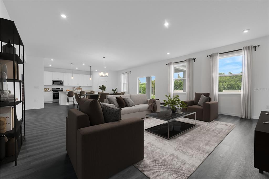 6032 Cliffbow Loop Leesburg, FL 34748 - Photo 8 of 31 a living room with furniture wooden floor and a large window