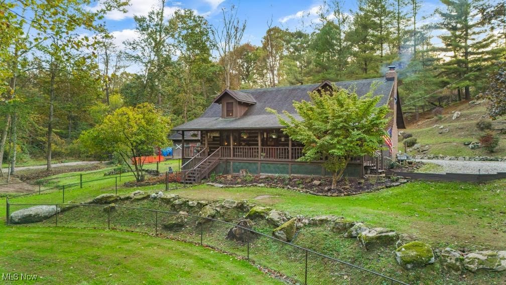 Rear view of property with a lawn