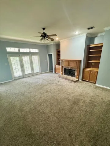 an empty room with furniture and a fireplace