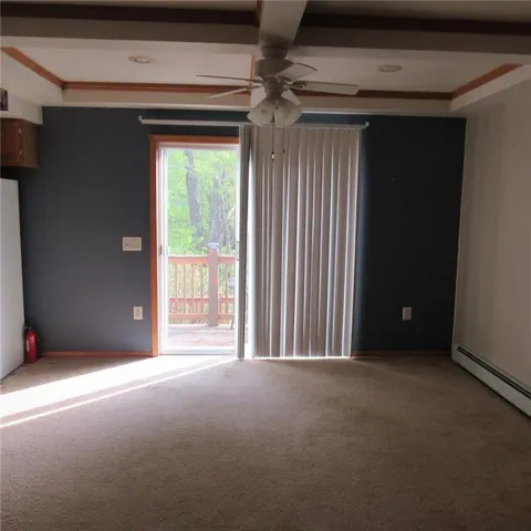 a view of a livingroom with an empty space and a window