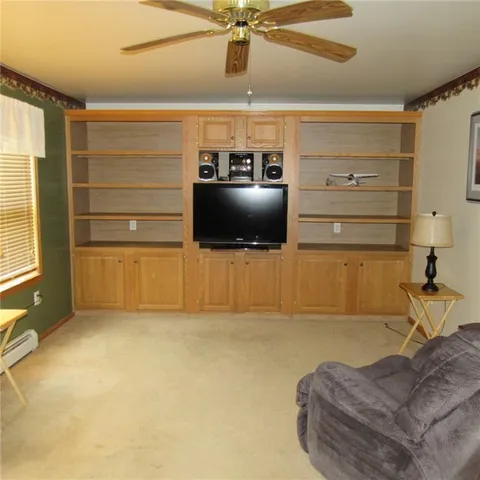 a living room with furniture and flat screen tv