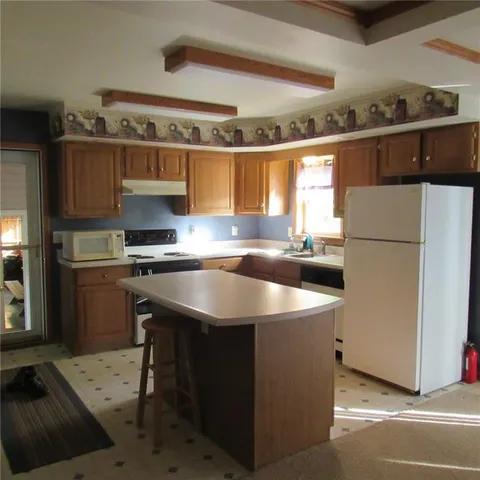a kitchen with a sink a refrigerator and a stove