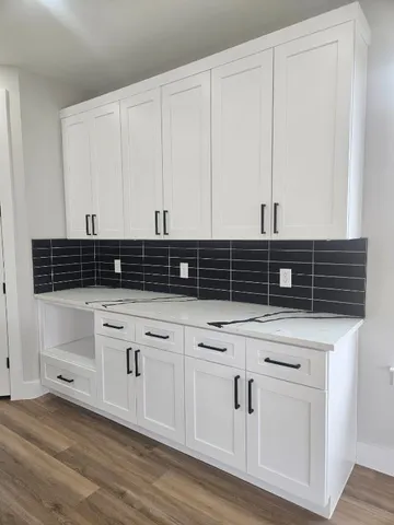 a kitchen with stainless steel appliances granite countertop a stove and a microwave