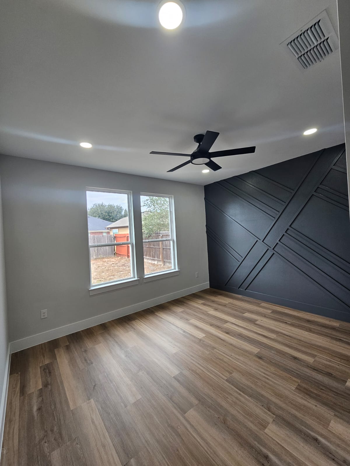2413 Blue Sky Lane Lockhart, TX 78644 - Photo 16 of 39 Unfurnished room featuring light wood-style flooring, recessed lighting, an accent wall, and a ceiling fan