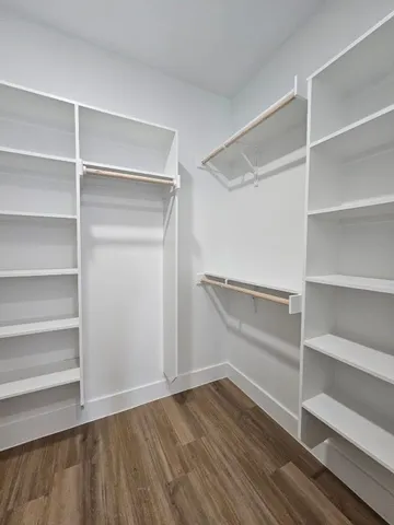 a view of walk in closet with empty racks