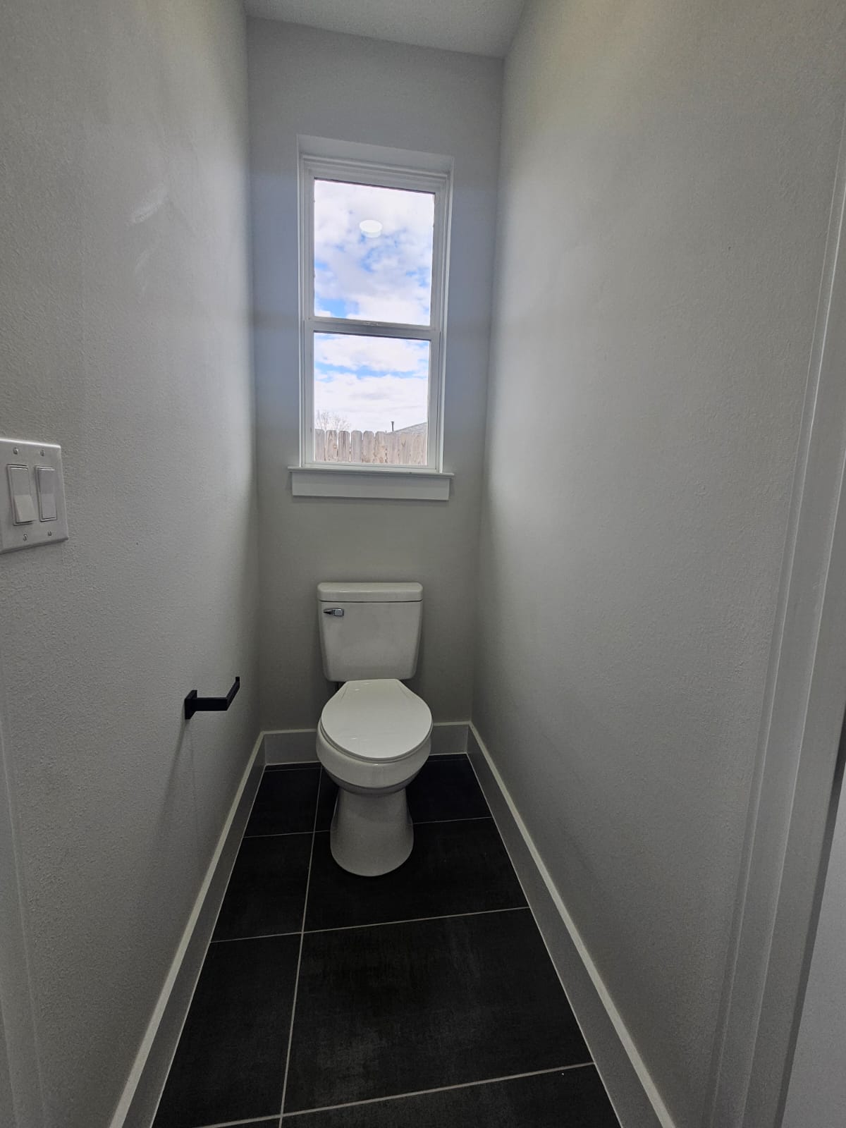 2413 Blue Sky Lane Lockhart, TX 78644 - Photo 21 of 39 Bathroom featuring dark tile patterned floors and baseboards