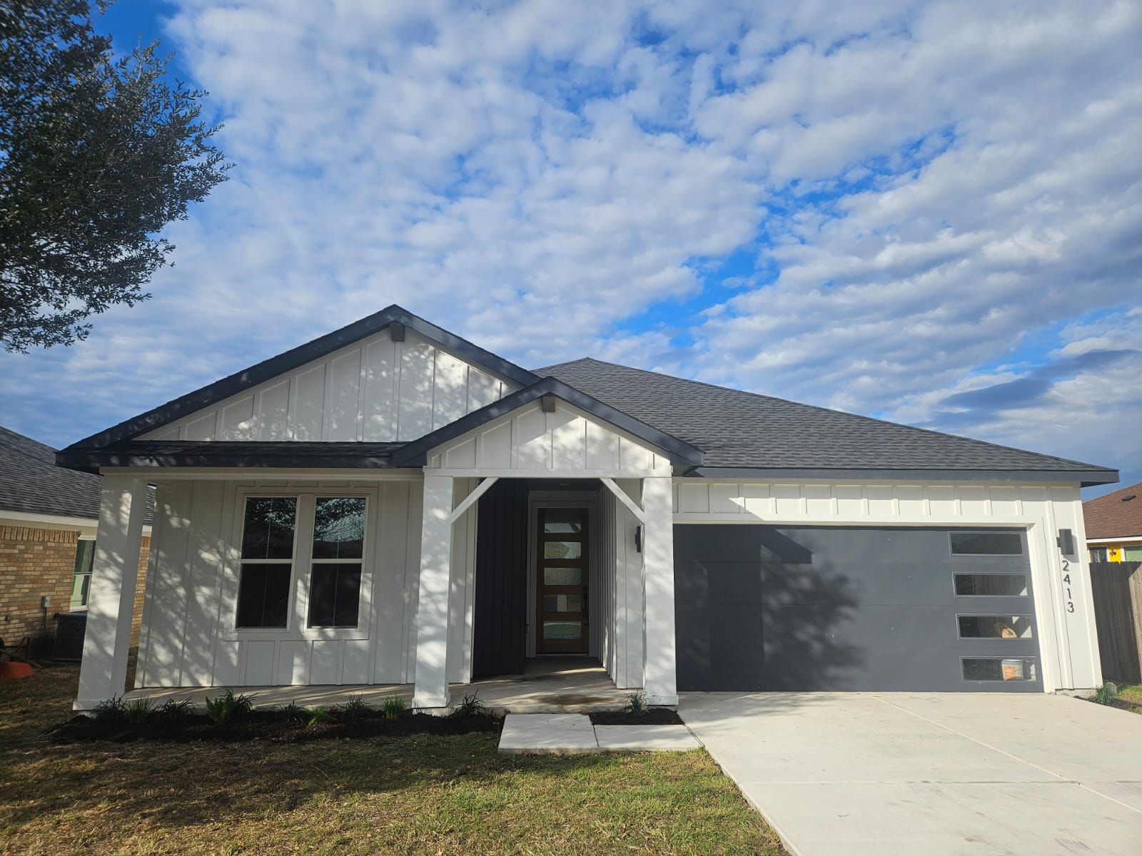 2413 Blue Sky Lane Lockhart, TX 78644 - Photo 3 of 39 View of front facade featuring concrete driveway, a garage, and a shingled roof