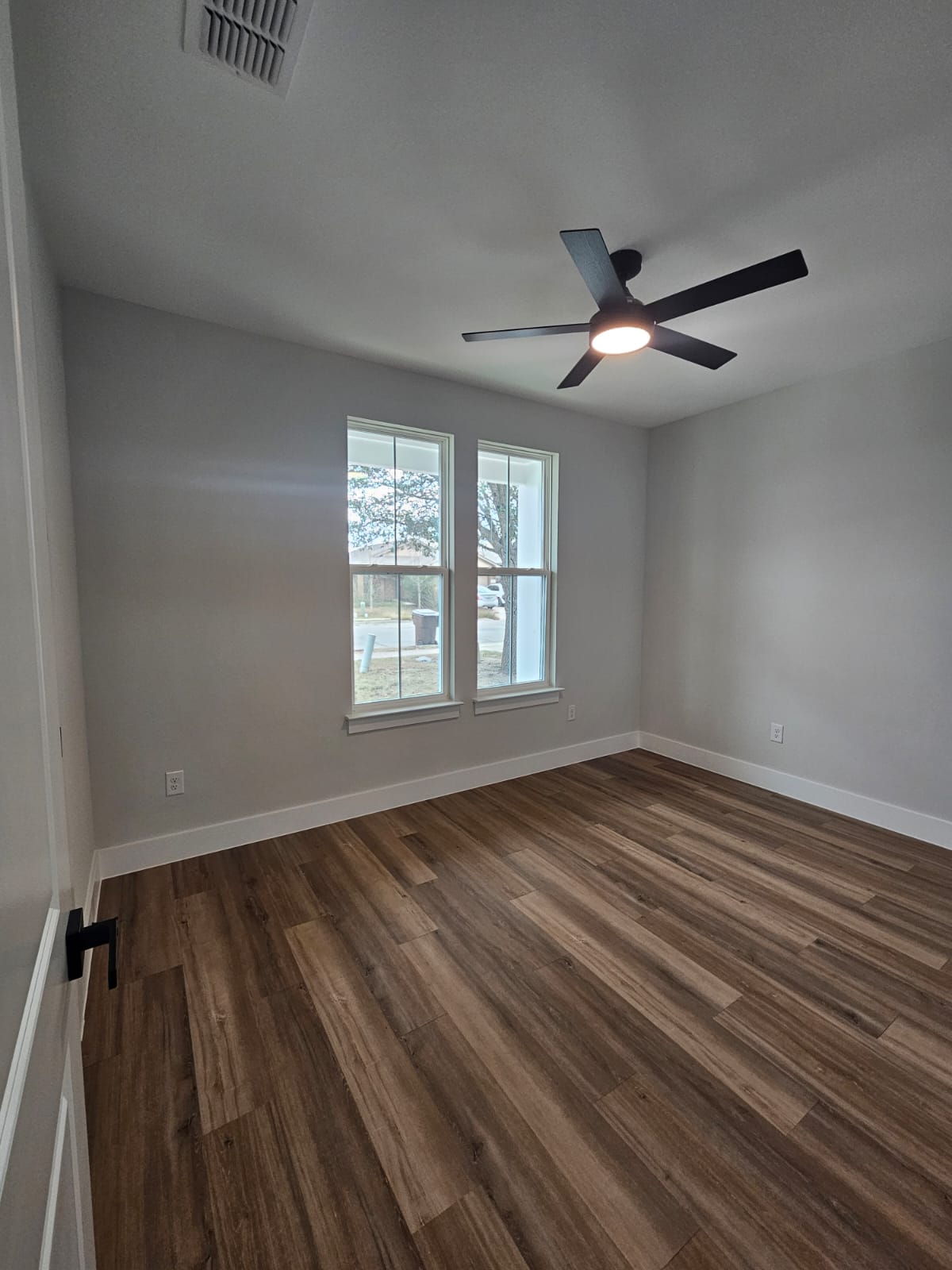 2413 Blue Sky Lane Lockhart, TX 78644 - Photo 33 of 39 Unfurnished room featuring dark wood finished floors and a ceiling fan