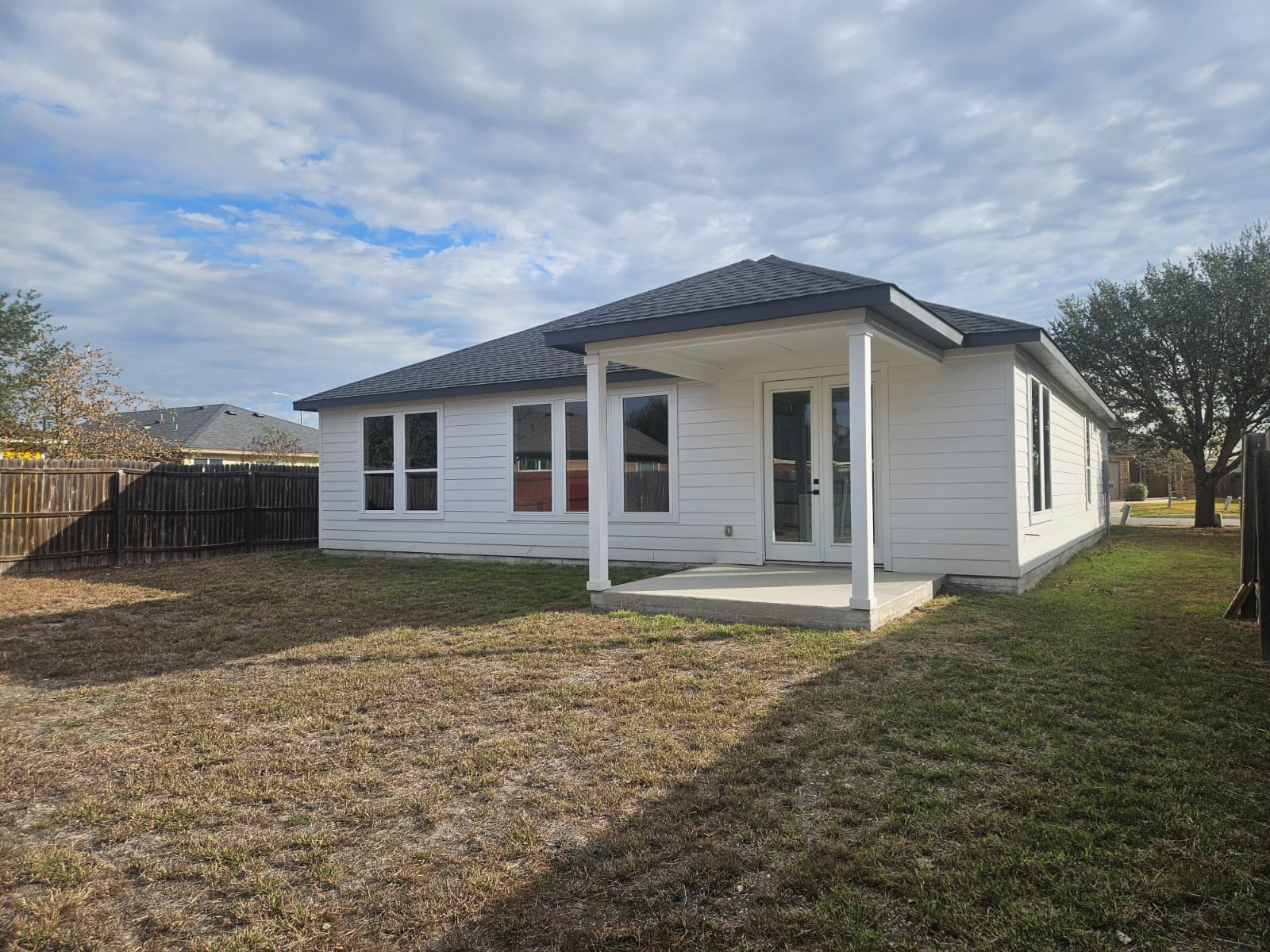 2413 Blue Sky Lane Lockhart, TX 78644 - Photo 35 of 39 Back of house with a patio area and a shingled roof