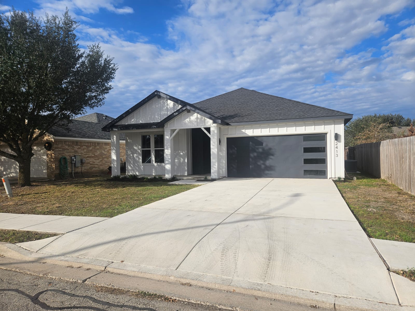 2413 Blue Sky Lane Lockhart, TX 78644 - Photo 4 of 39 View of front of property with roof with shingles, driveway, and an attached garage