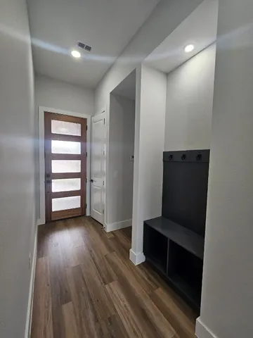 an empty room with wooden floor and closet