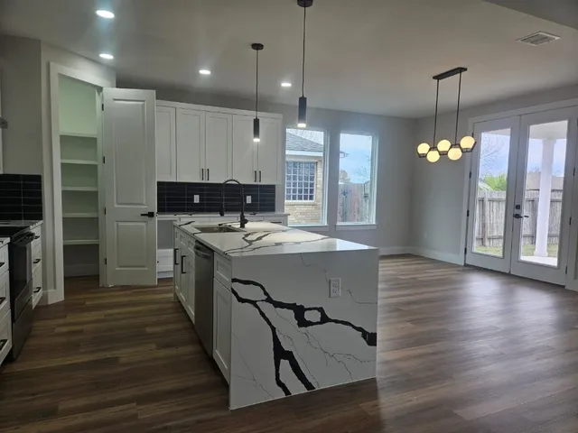 a view of kitchen with cabinets and wooden floor