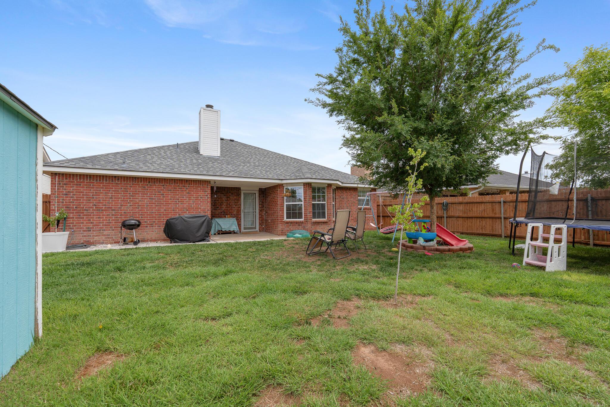 4010 Ross Street Amarillo, TX 79118 - Photo 23 of 26 Yard to house view - nice sized tree