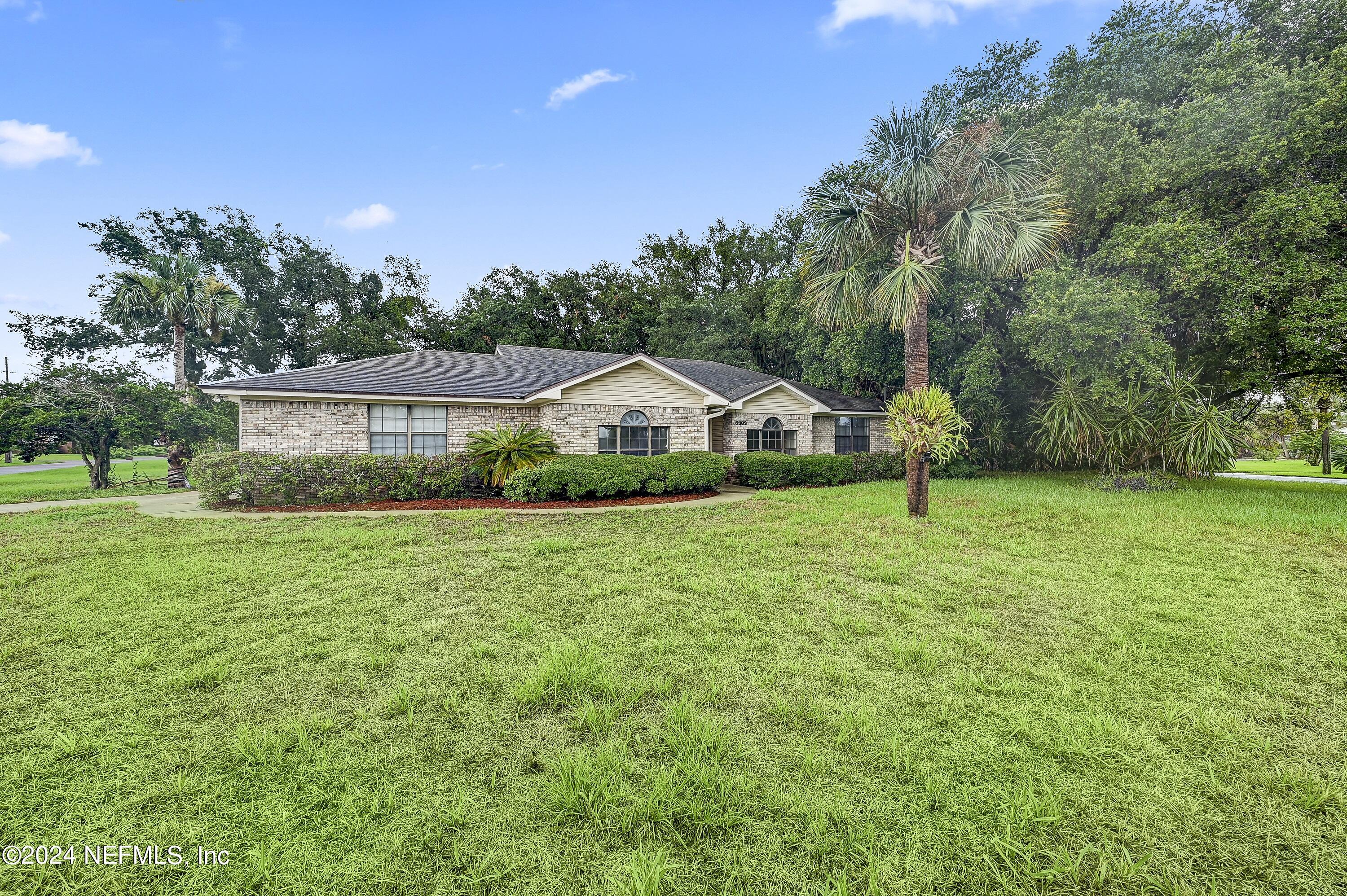 a view of a house with a yard
