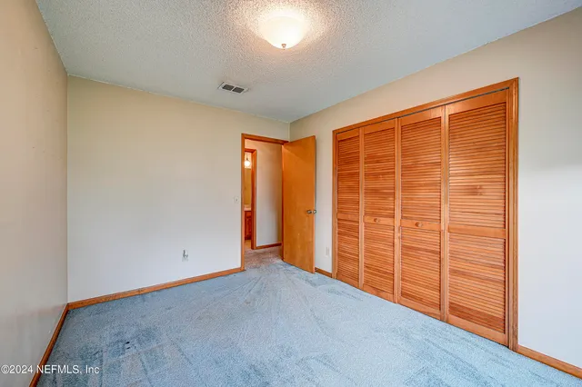 an empty room with wooden floor and walls