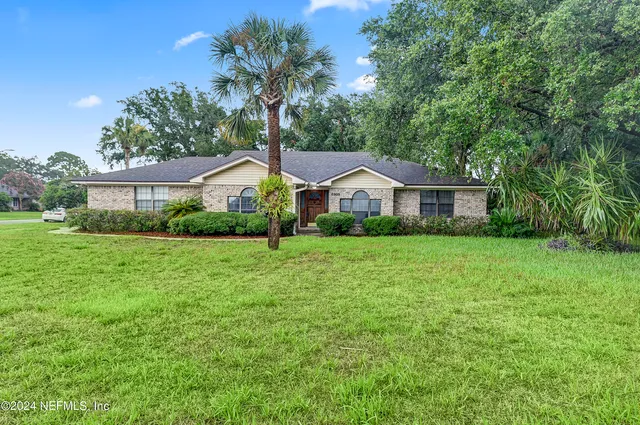 a front view of house with yard and green space