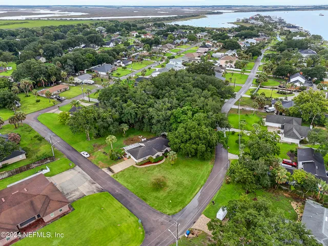 an aerial view of a residential houses with outdoor space and street view