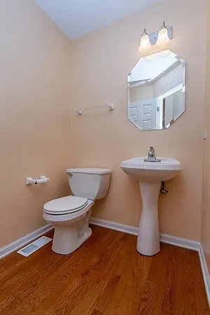 a white toilet sitting next to a bathroom sink