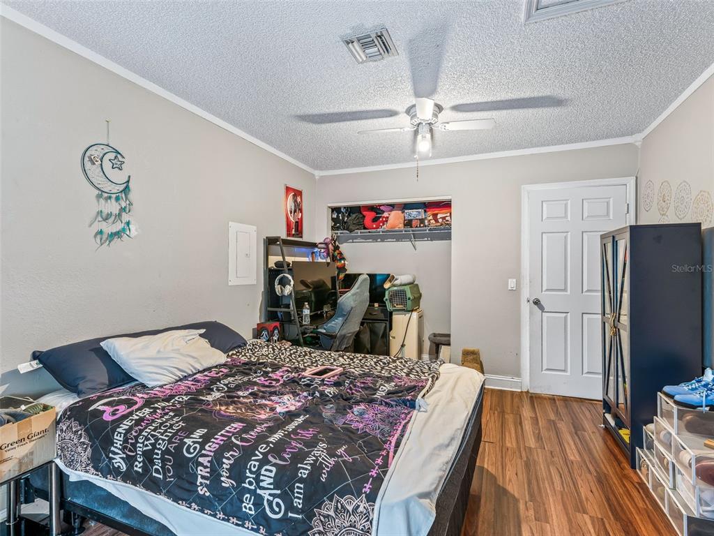 911 Jacaranda Drive Lady Lake, FL 32159 - Photo 16 of 24 a bedroom with a bed and a dresser