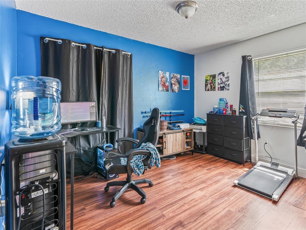 911 Jacaranda Drive Lady Lake, FL 32159 - Photo 17 of 24 a room with furniture and wooden floor