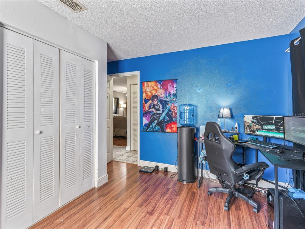 911 Jacaranda Drive Lady Lake, FL 32159 - Photo 18 of 24 a view of a workspace with furniture and wooden floor
