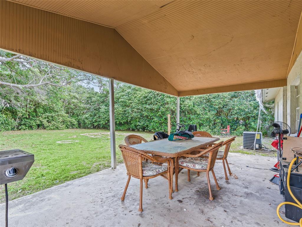 911 Jacaranda Drive Lady Lake, FL 32159 - Photo 20 of 24 a table and chairs with the view of garden
