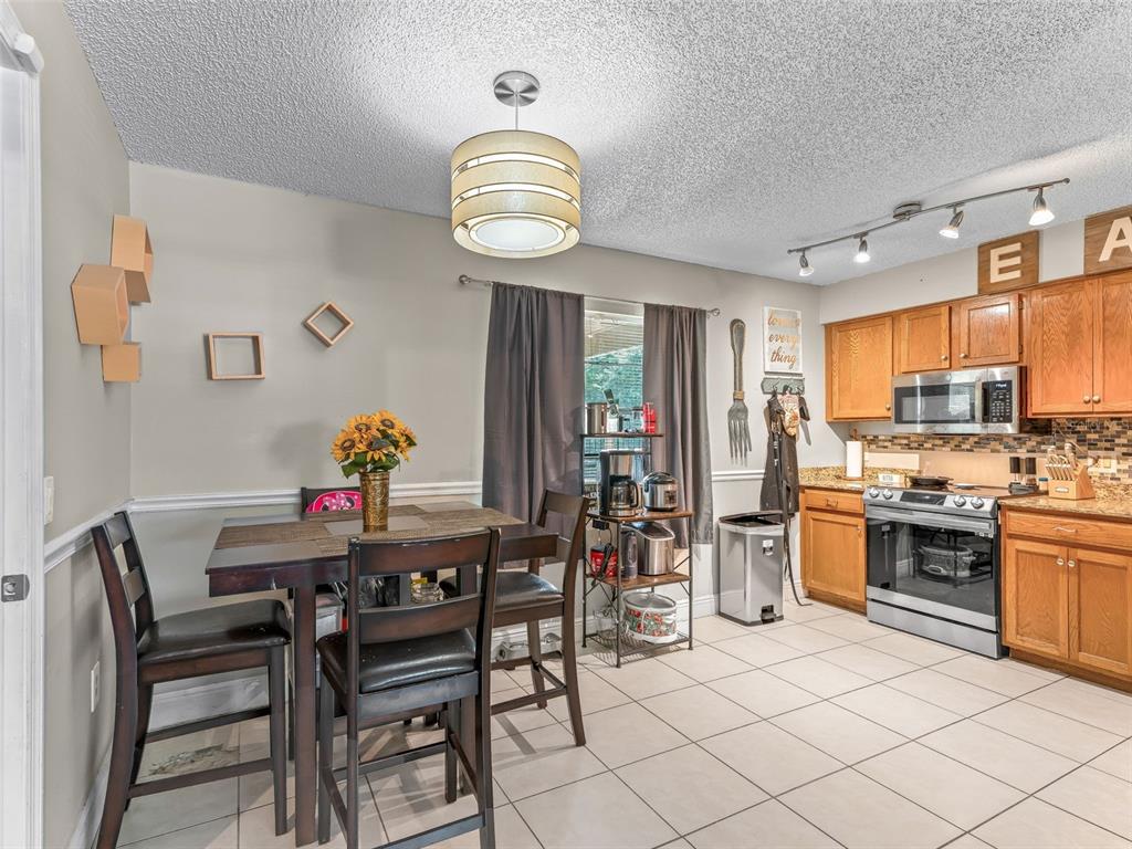 911 Jacaranda Drive Lady Lake, FL 32159 - Photo 6 of 24 a view of kitchen with sink dining table and chairs