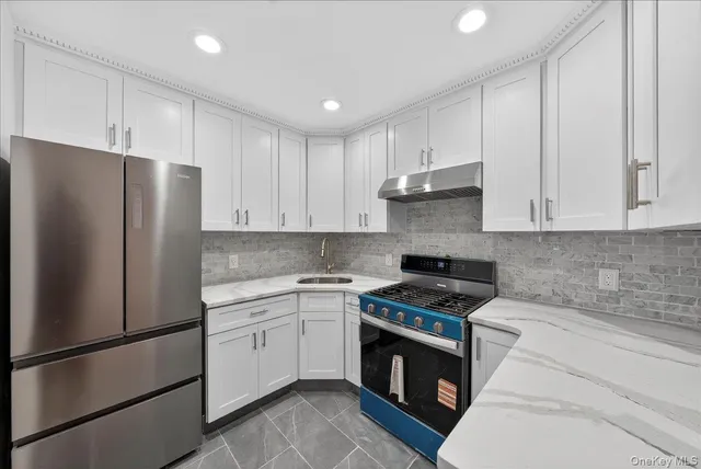 a kitchen with cabinets and stainless steel appliances