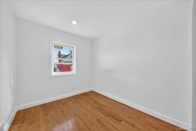 a view of a room with wooden floor and wall painting