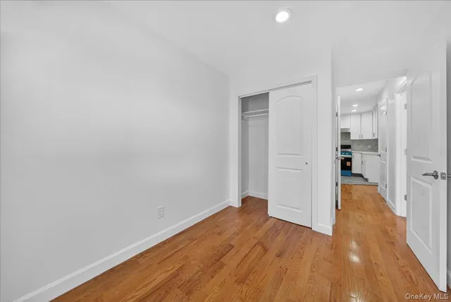 a view of a big room with wooden floor and windows